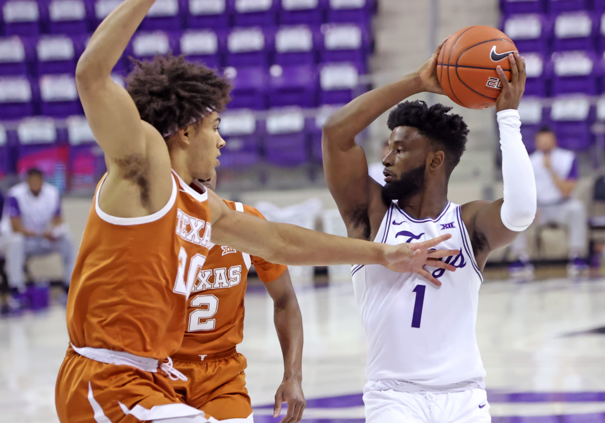 Mar 7, 2021; Fort Worth, Texas, USA; TCU Horned Frogs guard Mike Miles (1) looks to pass as Texas Longhorns forward Jericho Sims (20) defends during the first half at Ed and Rae Schollmaier Arena.