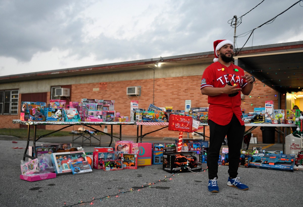 Texas Rangers' catcher and Corpus Christi native Jose Trevino removes his mask to film a promotion for his annual toy drive, Saturday, Dec. 19, 2020, at Westside Helping Hands. The toy drive purchased over $6,000 worth of toys for Christmas.