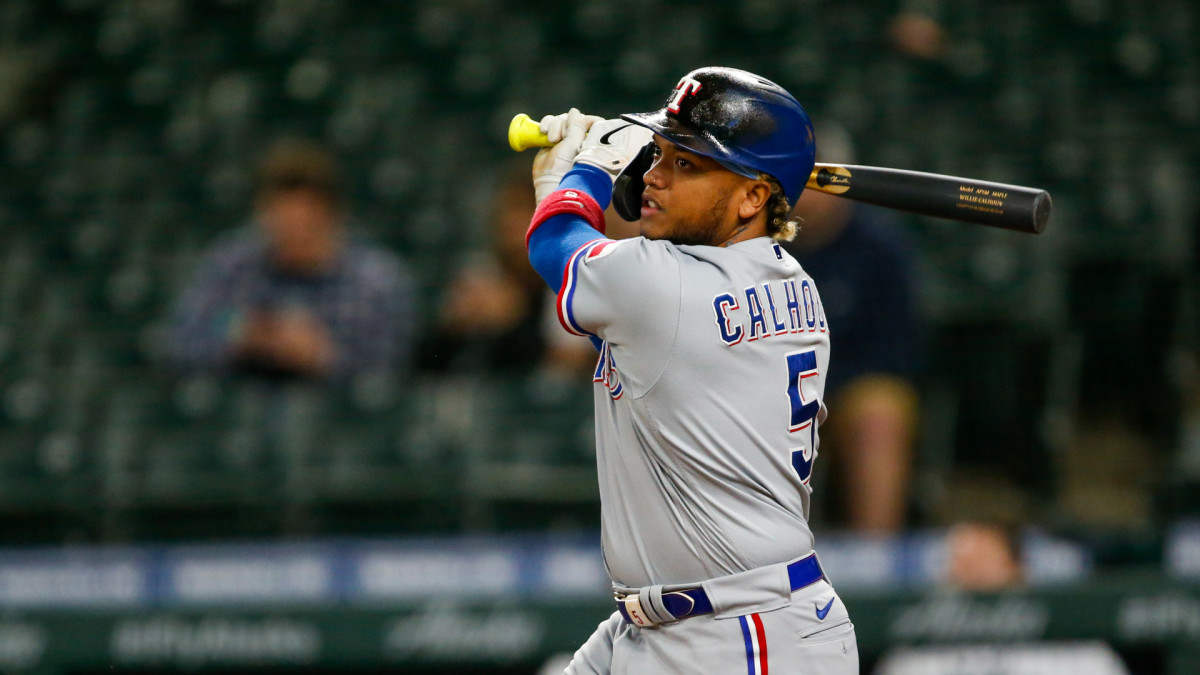 May 27, 2021; Seattle, Washington, USA; Texas Rangers designated hitter Willie Calhoun (5) hits a triple against the Seattle Mariners during the sixth inning at T-Mobile Park.