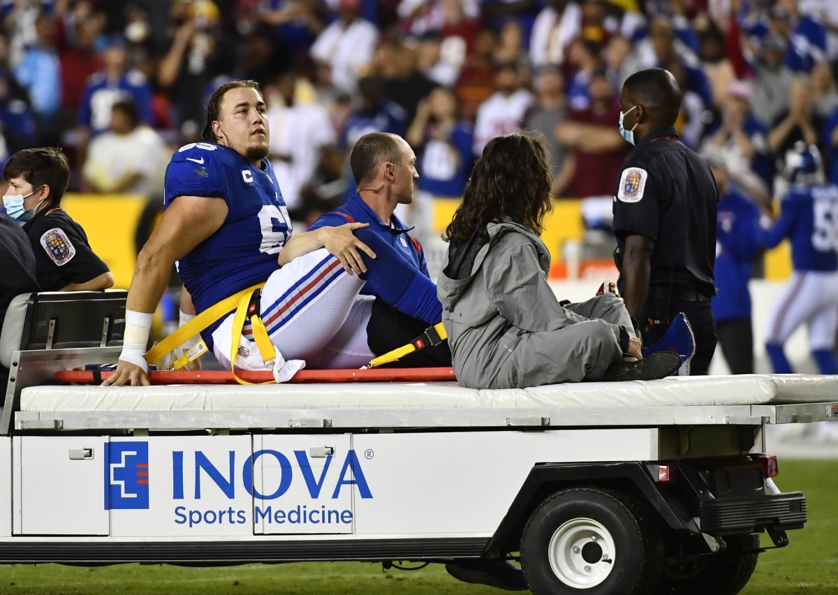 Sep 16, 2021; Landover, Maryland, USA; New York Giants center Nick Gates (65) reacts after suffering an apparent leg injury against the Washington Football Team during the first half at FedExField.