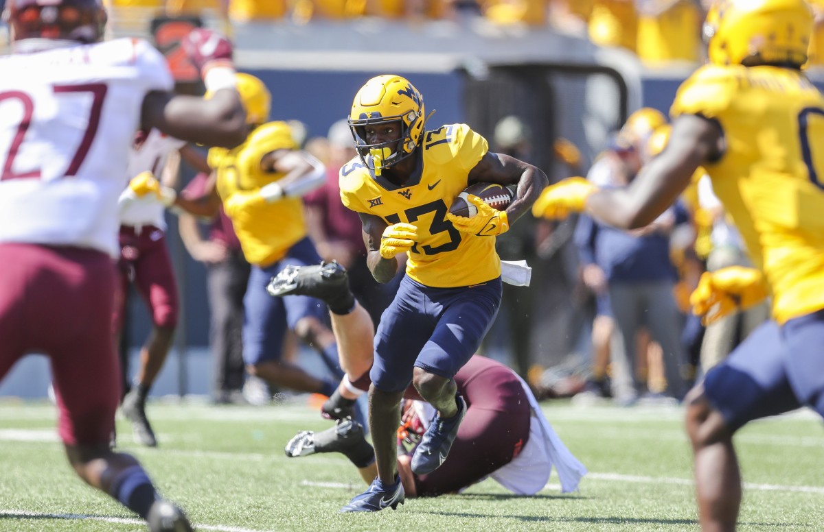 Sep 18, 2021; Morgantown, West Virginia, USA; West Virginia Mountaineers wide receiver Sam James (13) catches a pass and runs for a touchdown during the second quarter against the Virginia Tech Hokies at Mountaineer Field at Milan Puskar Stadium.