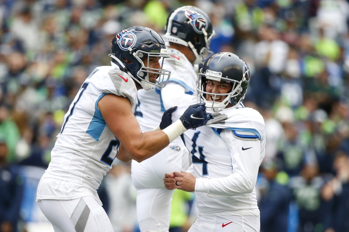Tennessee Titans kicker Randy Bullock (14) celebrates with tight end Geoff Swaim (87) after kicking a game-winning field goal in overtime against the Seattle Seahawks at Lumen Field.