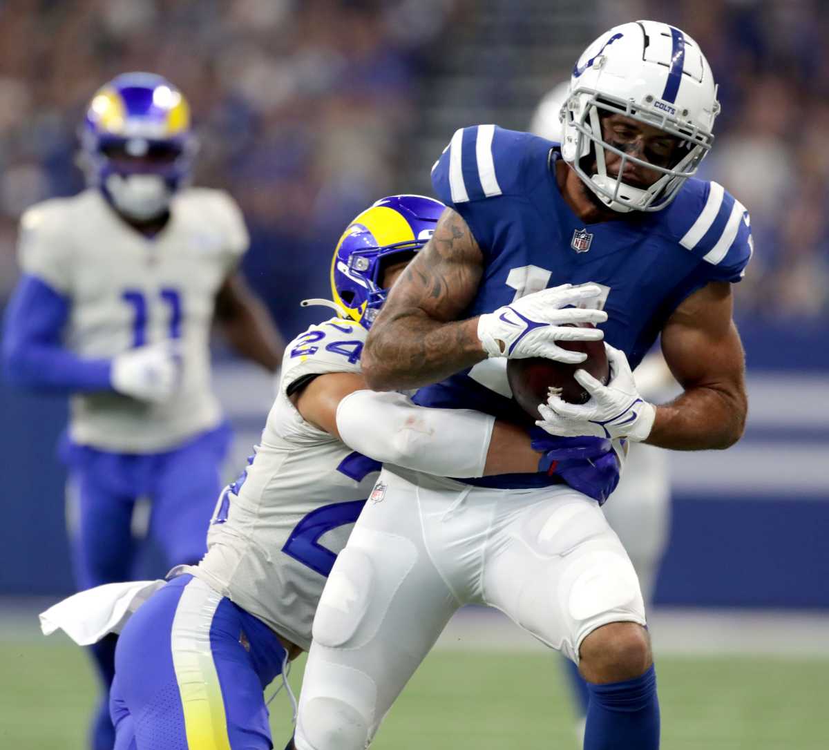 Los Angeles Rams safety Taylor Rapp (24) works to bring down Indianapolis Colts wide receiver Michael Pittman Jr. (11) on Sunday, Sept. 19, 2021, during a game against the Los Angeles Rams at Lucas Oil Stadium in Indianapolis.