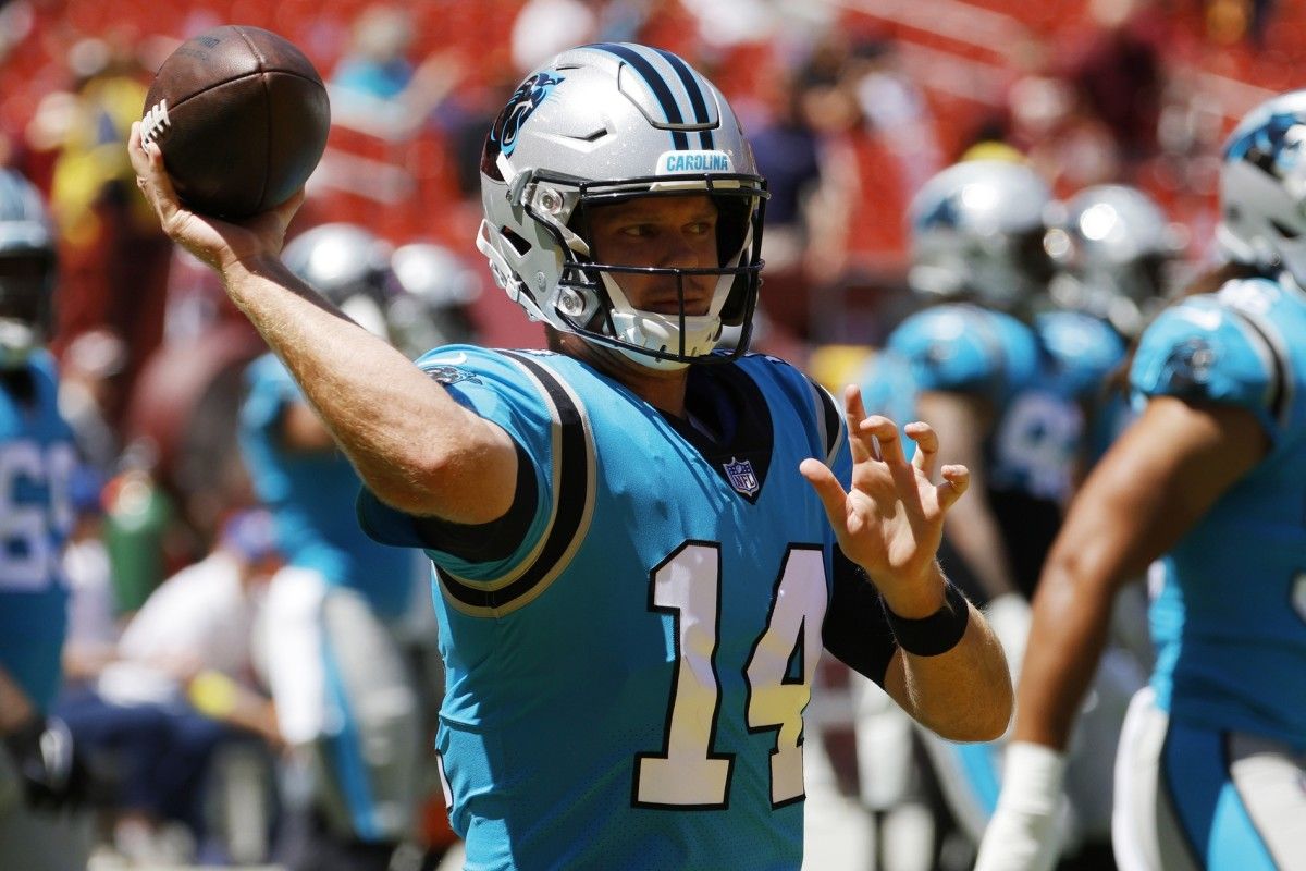Carolina Panthers quarterback Sam Darnold (14) passes a ball during warmups prior to the game against the Washington Commanders at FedExField.