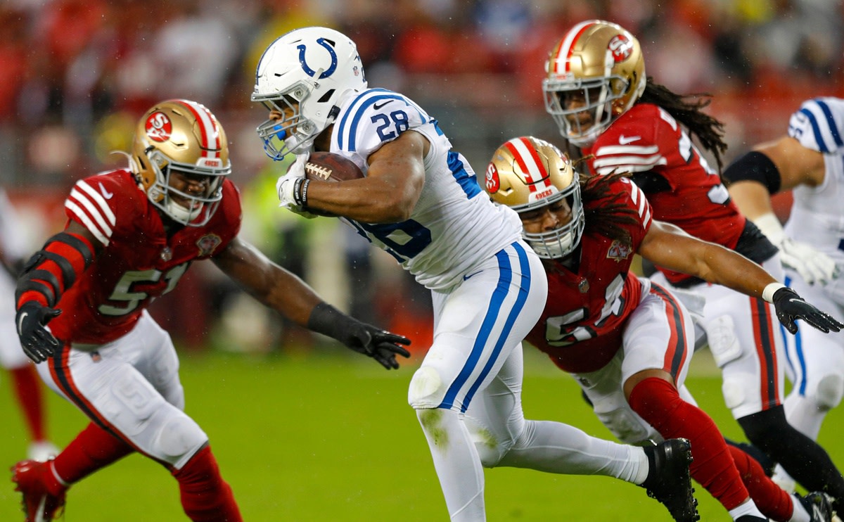 October 24, 2021; Indianapolis Colts running back Jonathan Taylor (28) is tackled by San Francisco 49ers linebackers Azeez Al-Shaair (51) and Fred Warner (54). © Robert Scheer/IndyStar / USA TODAY NETWORK