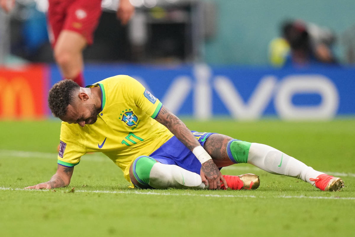 Neymar pictured on the ground during Brazil's 2-0 win over Serbia at the 2022 World Cup after sustaining ligament damage in his right ankle