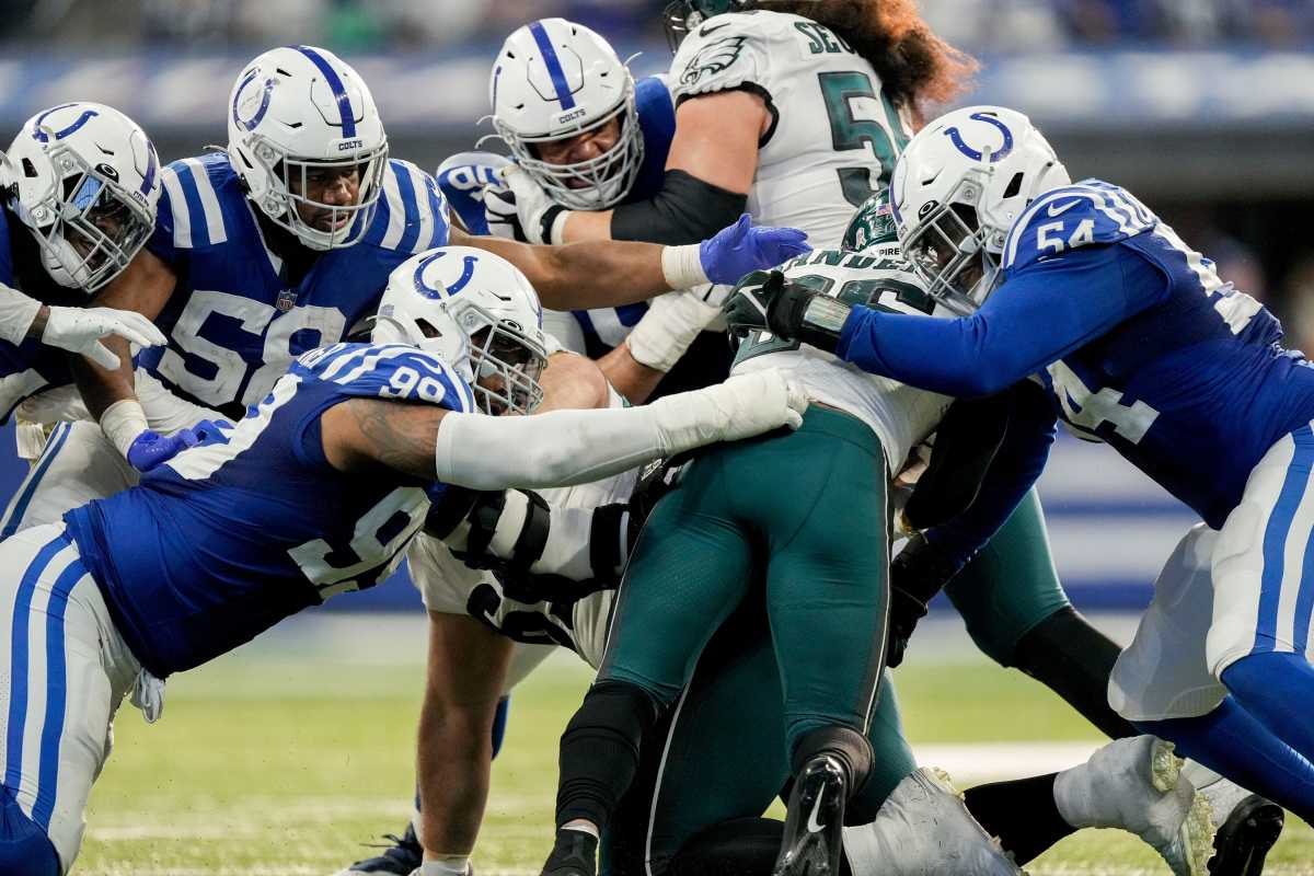 Indianapolis Colts defensive tackle DeForest Buckner (99) and Indianapolis Colts defensive end Dayo Odeyingbo (54) work to bring down Philadelphia Eagles running back Miles Sanders (26) on Sunday, Nov. 20, 2022, during a game against the Philadelphia Eagles at Lucas Oil Stadium in Indianapolis.