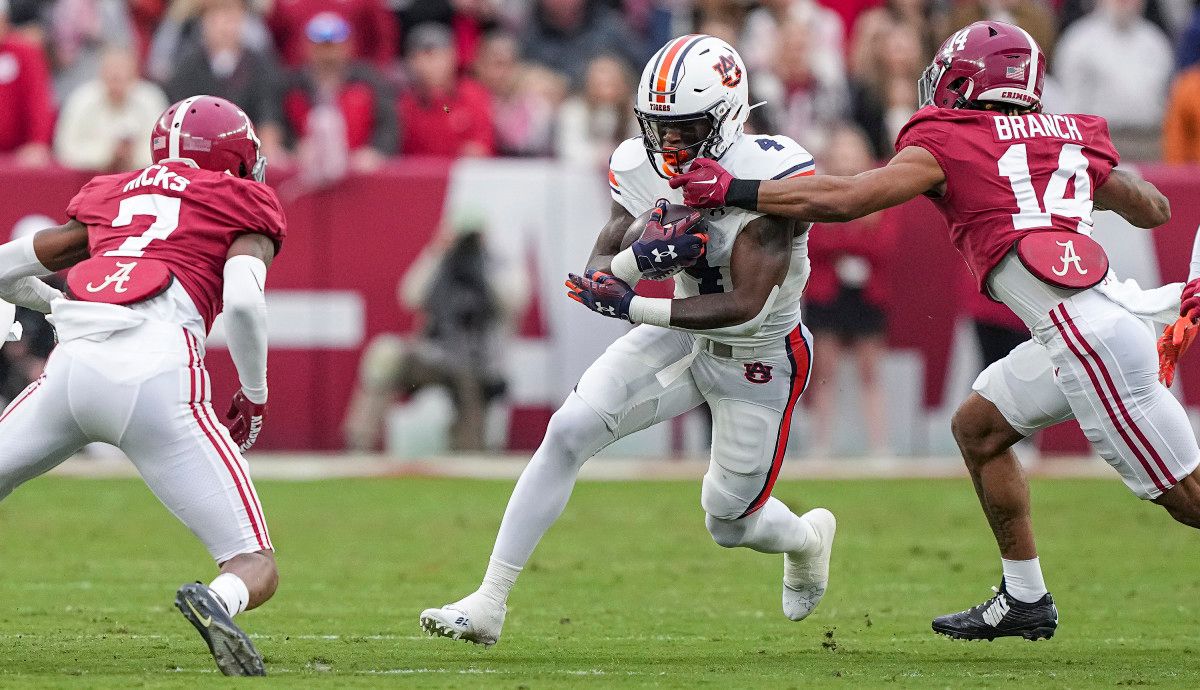 Tank Bigsby (4) tries to break through the tackle during the game between Auburn and Alabama at Bryant-Denny Stadium. Austin Perryman/AU Athletics