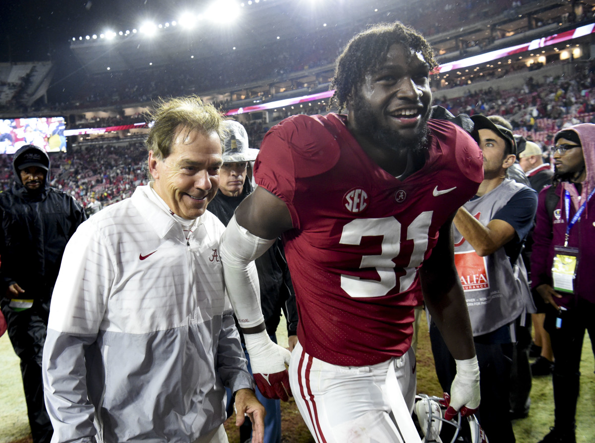 Alabama Crimson Tide head coach Nick Saban and linebacker Will Anderson Jr. (31) share a smile as they leave the field after defeating the Auburn Tigers at Bryant-Denny Stadium. Alabama won 49-27.