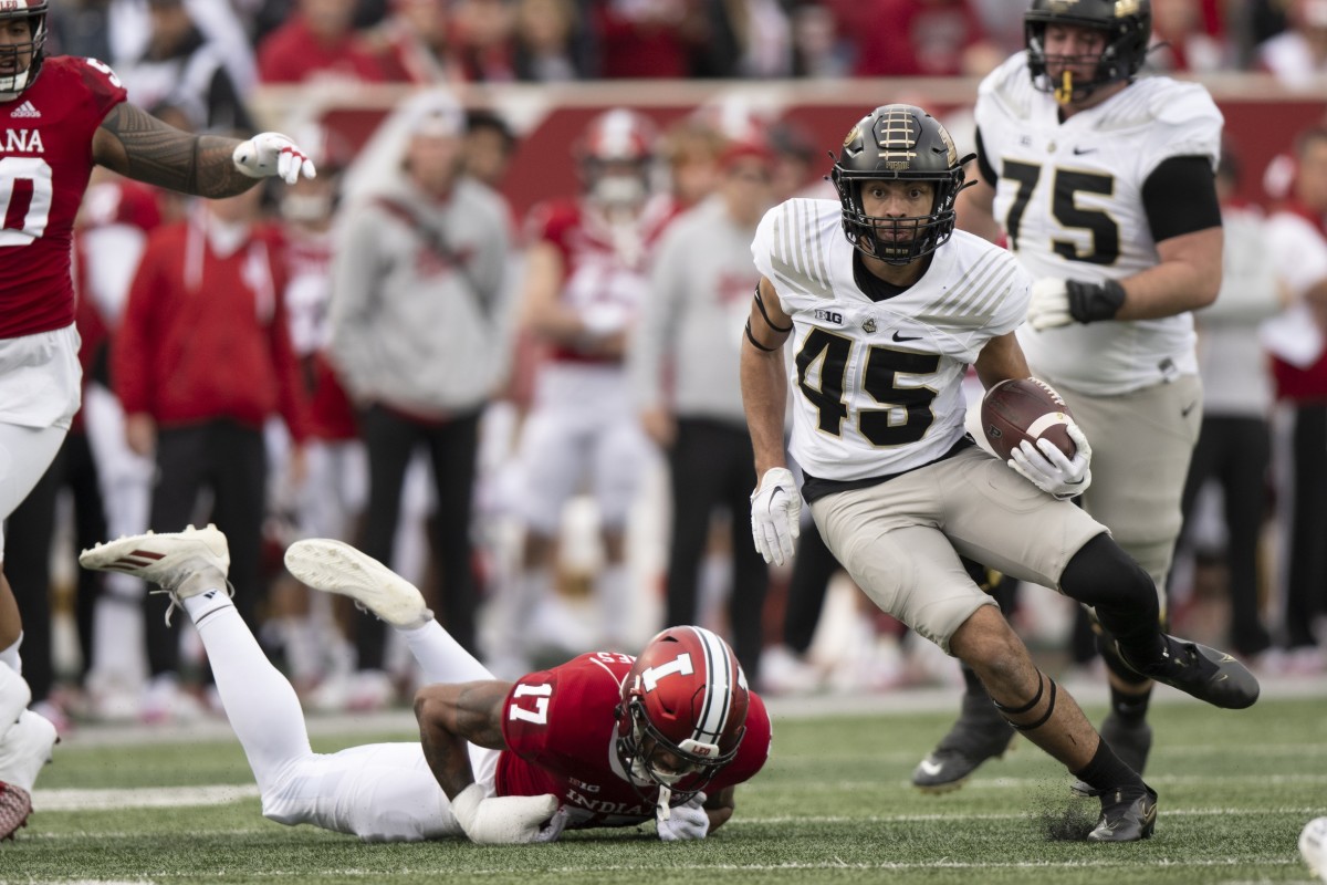 Nov 26, 2022; Bloomington, Indiana, USA; Purdue Boilermakers running back Devin Mockobee (45) evades tackle by Indiana Hoosiers defensive back Jonathan Haynes (17) during the first quarter at Memorial Stadium.