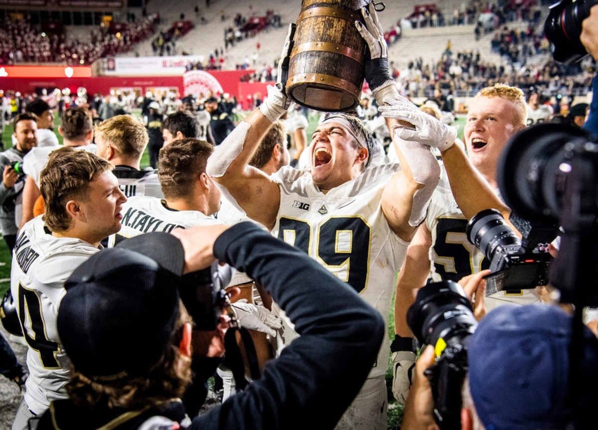 Purdue's Jack Sullivan (99) and the Boilermakers celebrate with the Old Oaken Bucket after the Indiana versus Purdue football game at Memorial Stadium on Saturday, Nov. 26, 2022.