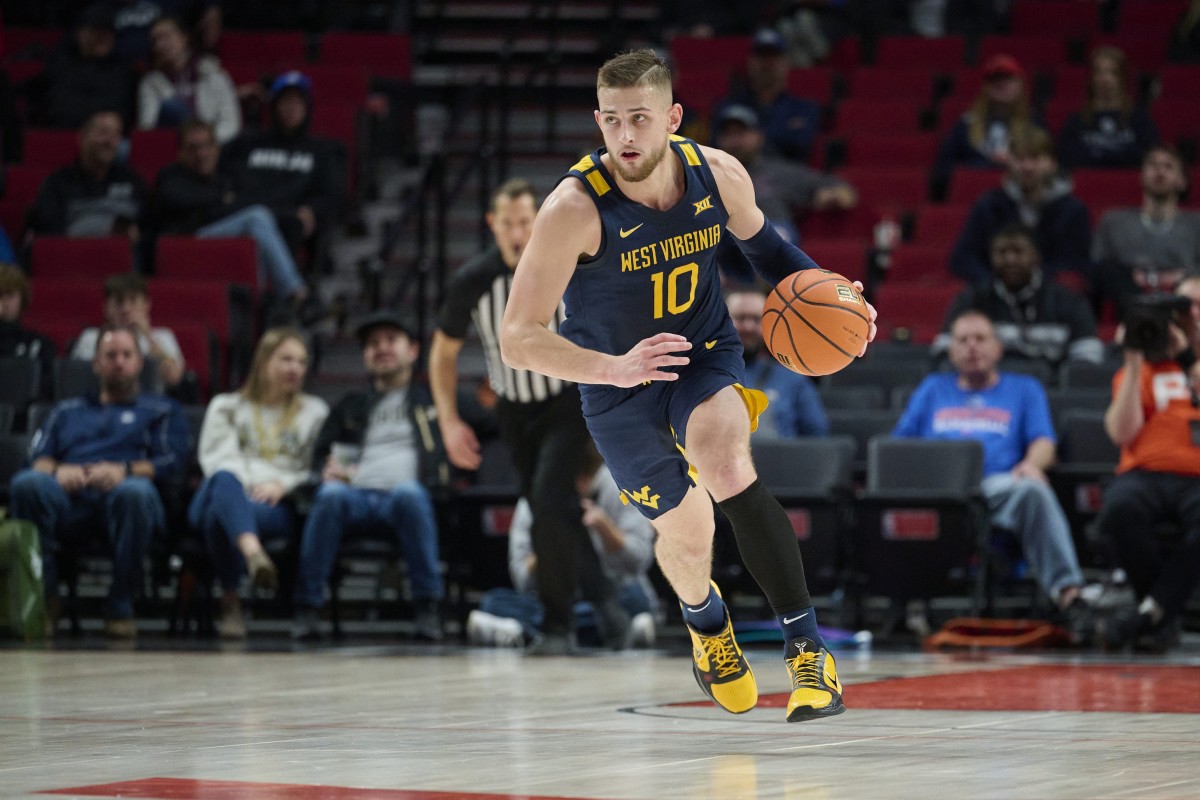Nov 25, 2022; Portland, Oregon, USA; West Virginia Mountaineers guard Erik Stevenson (10) takes the ball up the court during the first half against the Portland State Vikings at Moda Center.