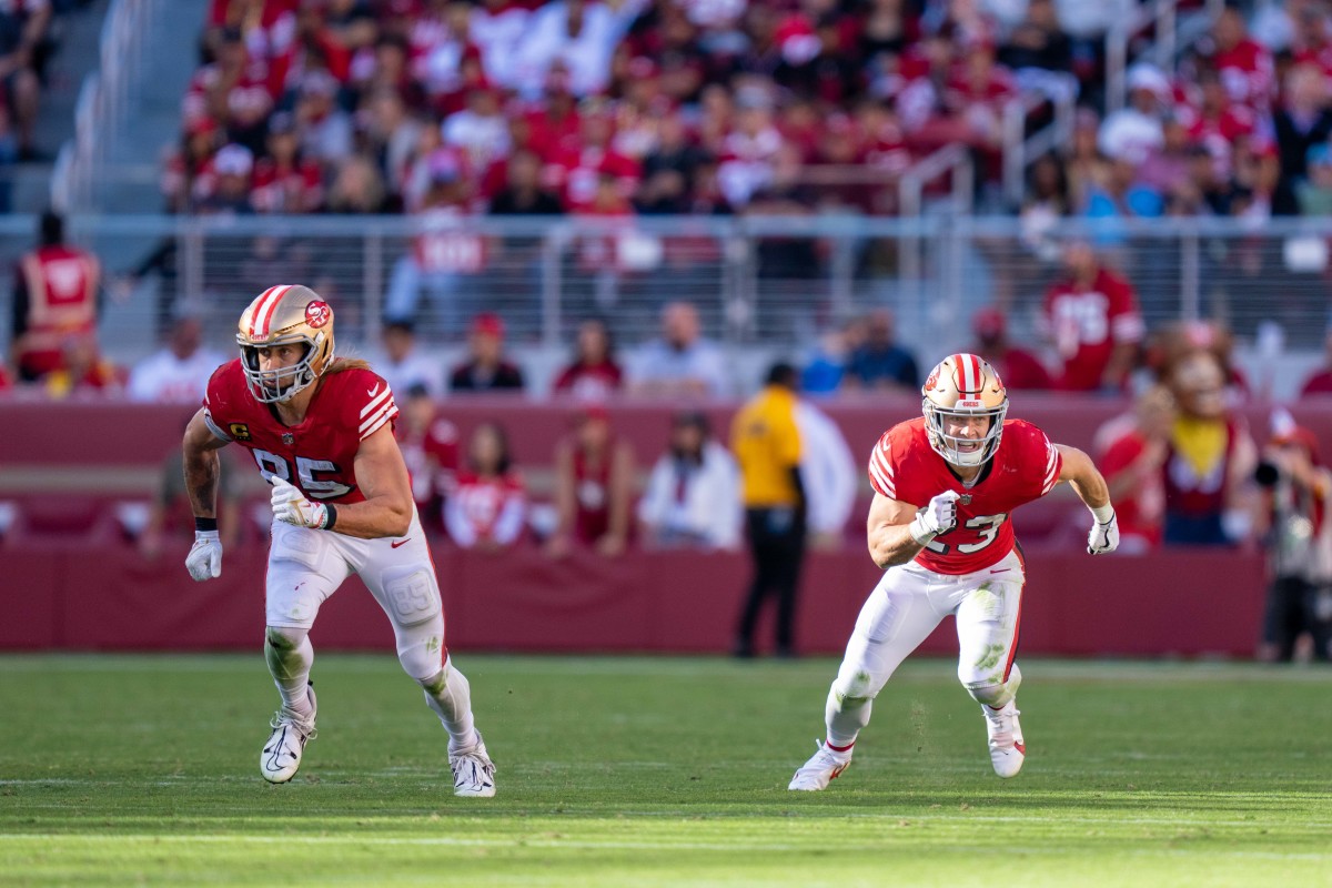 George Kittle and Christian McCaffrey run routes off the line of scrimmage