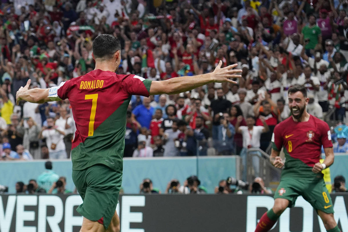 Cristiano Ronaldo pictured (left) celebrating with Bruno Fernandes during Portugal's game against Uruguay at the 2022 World Cup