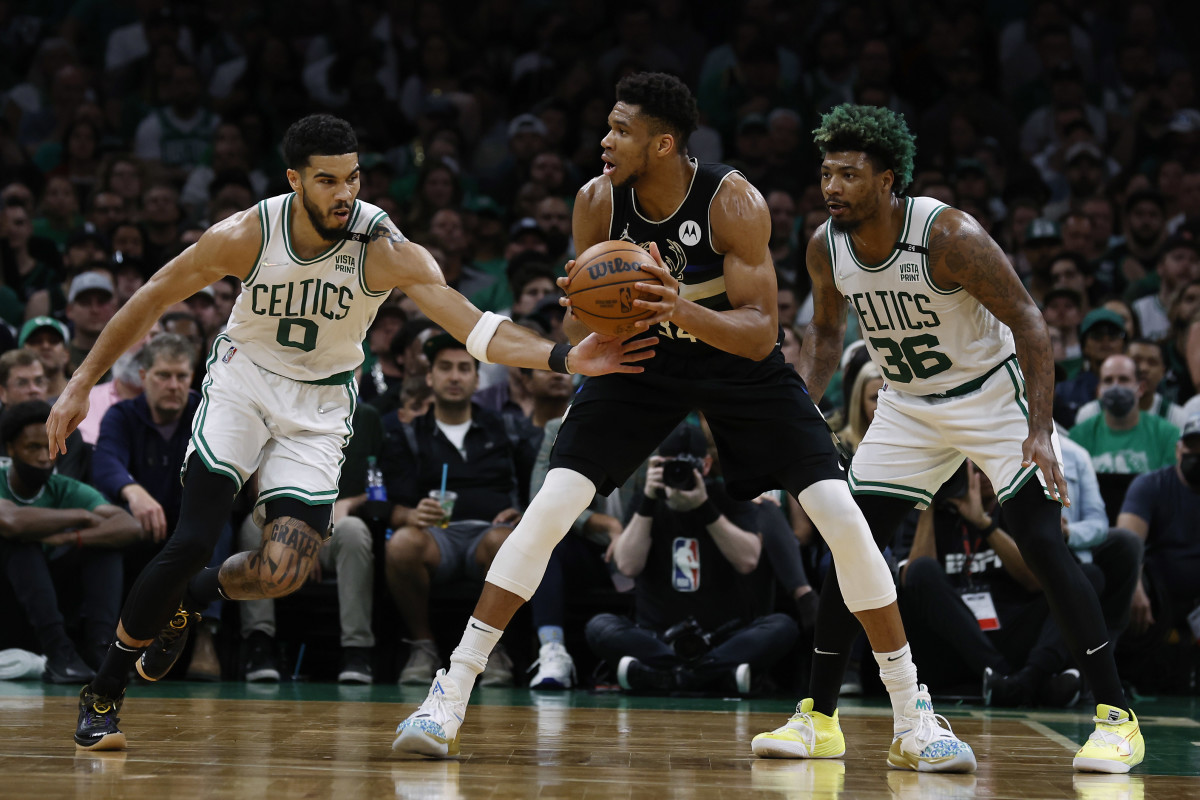 Boston Celtics forward Jayson Tatum (0) tries to steal the ball from Milwaukee Bucks forward Giannis Antetokounmpo