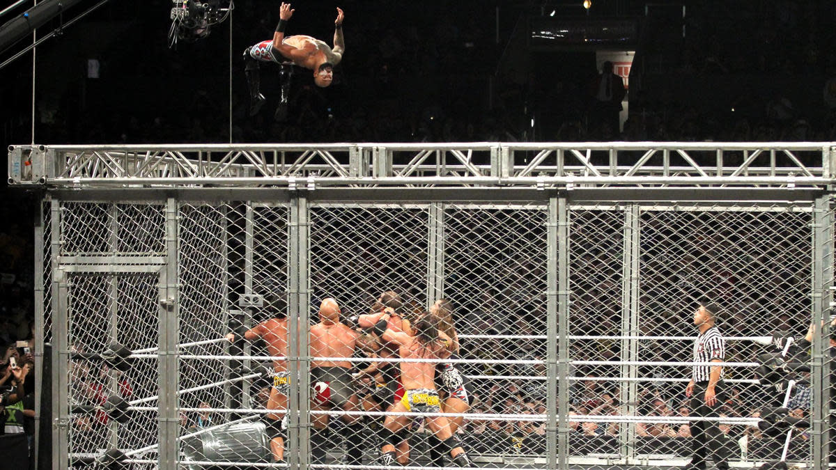 Ricochet performs a moonsault from the top of the cage at "NXT TakeOver: WarGames" in 2018.