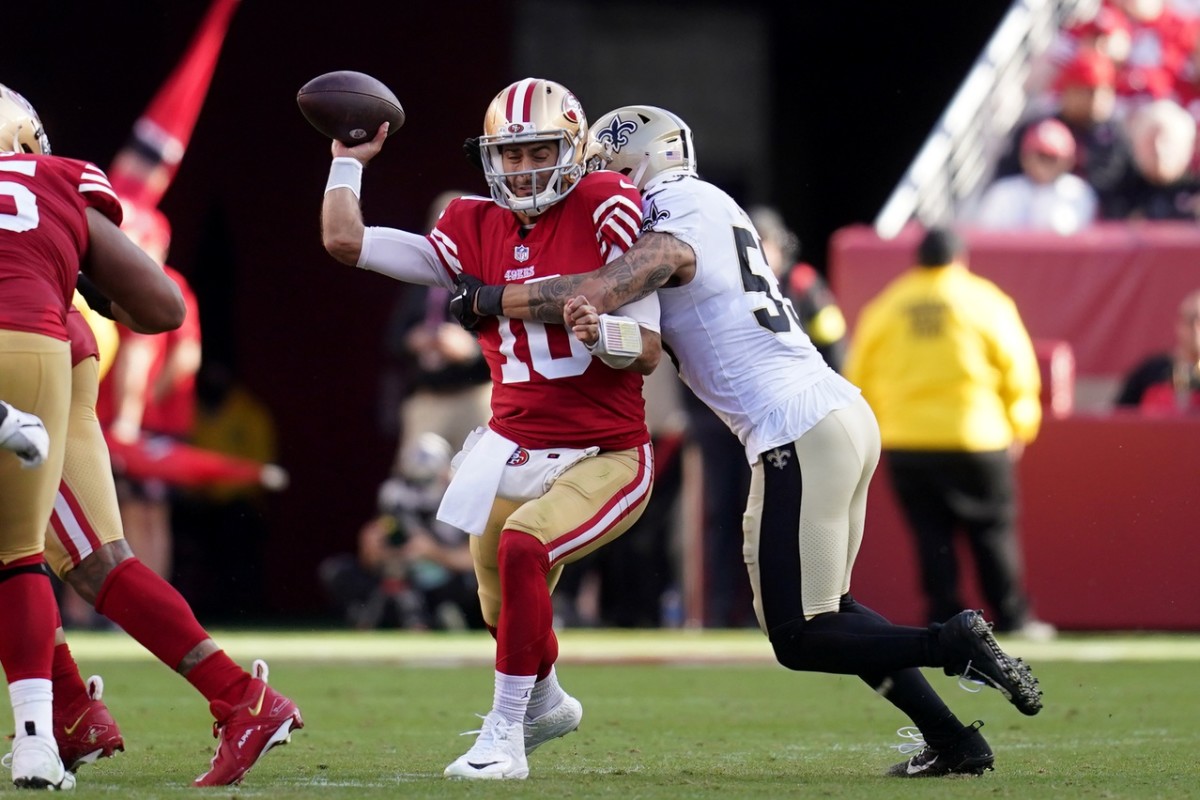 San Francisco 49ers quarterback Jimmy Garoppolo (10) is hit by New Orleans Saints linebacker Zack Baun (53) while throwing. Mandatory Credit: Cary Edmondson-USA TODAY Sports