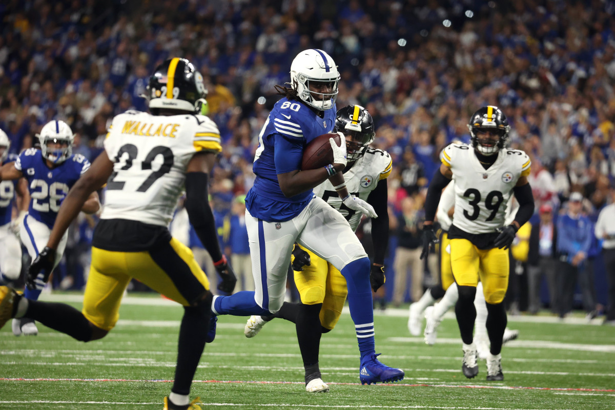 Nov 28, 2022; Indianapolis, Indiana, USA; Indianapolis Colts tight end Jelani Woods (80) runs with the ball after a catch as Pittsburgh Steelers cornerback Levi Wallace (29) defends during the second half at Lucas Oil Stadium.