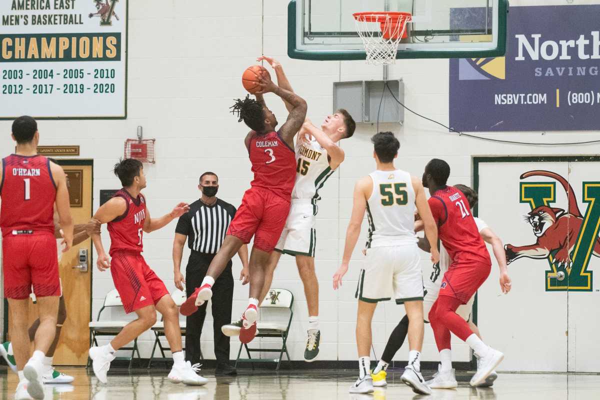 Vermont s Nick Fiorillo (15) tries to block the shot by NJIT s Miles Coleman (3) during the men s basketball game between the NJIT vs. Vermont at Patrick Gym on Sunday afternoon December 27, 2020 in Burlington, Vermont. Njit Vs Vermont Men S Basketball 12 27 20