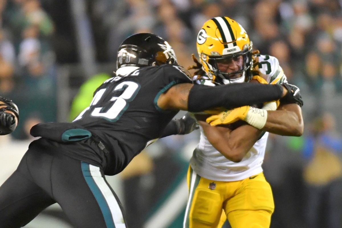 Nov 27, 2022; Philadelphia, Pennsylvania, USA; Green Bay Packers running back Aaron Jones (33) is tackled by Philadelphia Eagles linebacker Kyzir White (43) during the third quarter at Lincoln Financial Field.