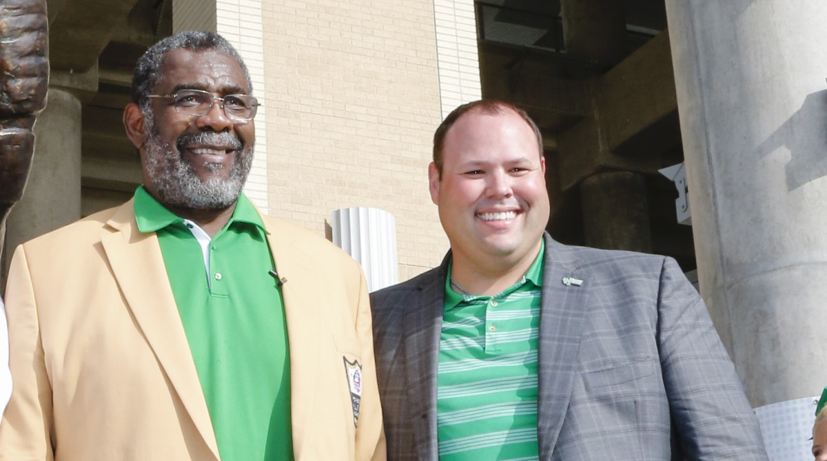 North Texas Athletic Director Wren Baker (right) at the school’s statue unveiling for Hall of Famer “Mean” Joe Greene.