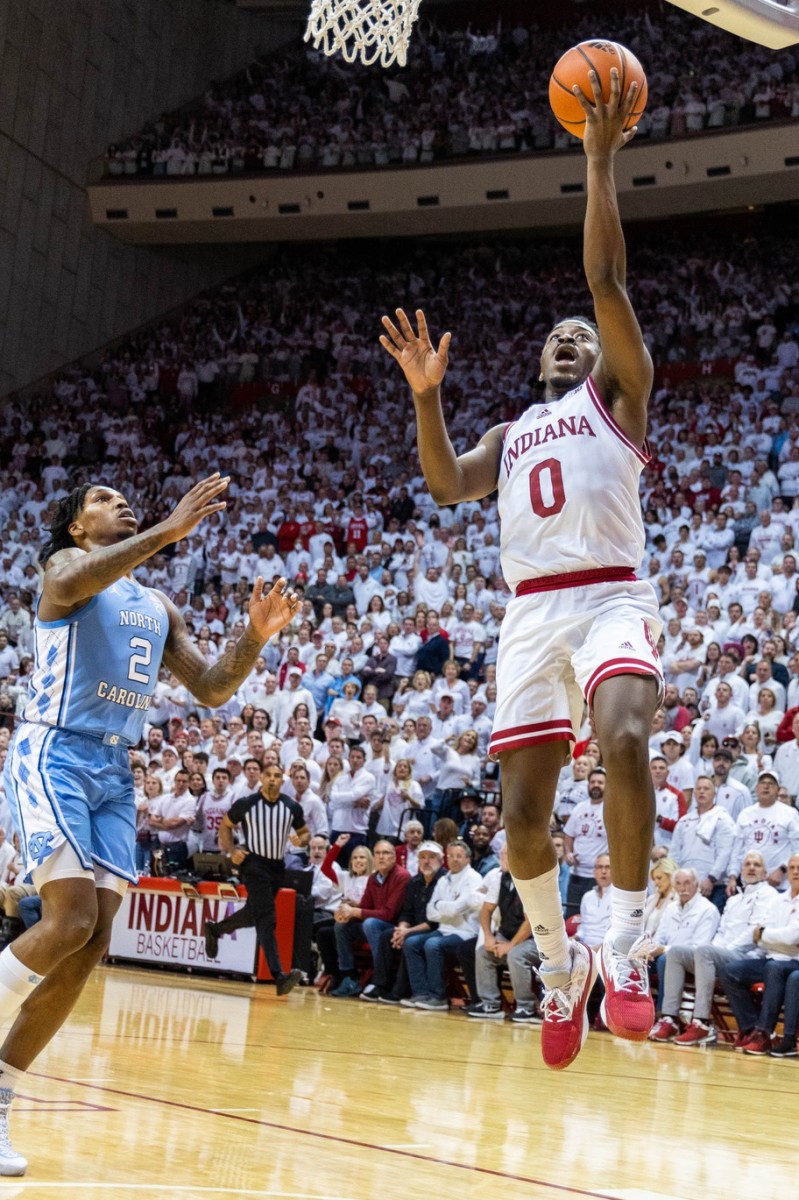 Indiana Hoosiers guard Xavier Johnson (0) shoots the ball while North Carolina Tar Heels guard Caleb Love (2) defends in the first half at Simon Skjodt Assembly Hall.