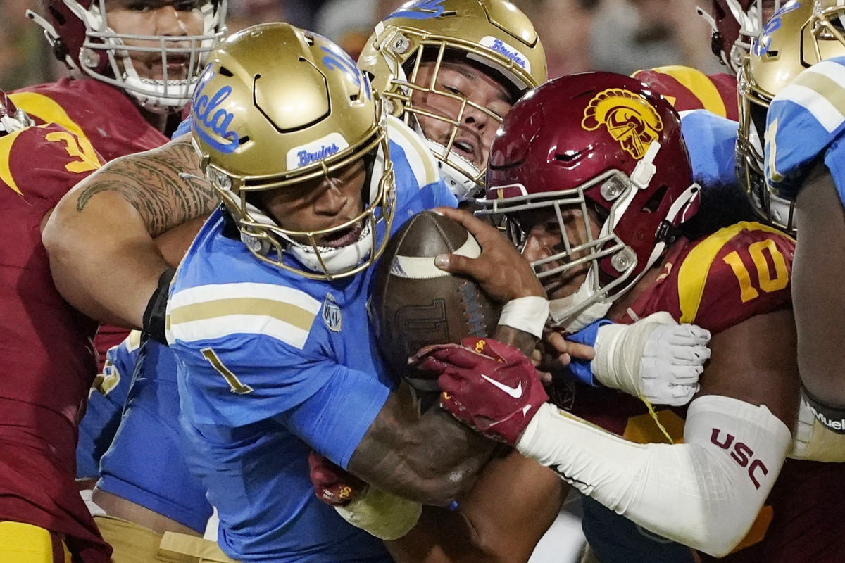 UCLA quarterback Dorian Thompson-Robinson (1) heads in for a touchdown as Southern California linebacker Ralen Goforth (10) tries to stop him during the first half of an NCAA college football game Saturday, Nov. 19, 2022, in Pasadena, Calif. (AP Photo/