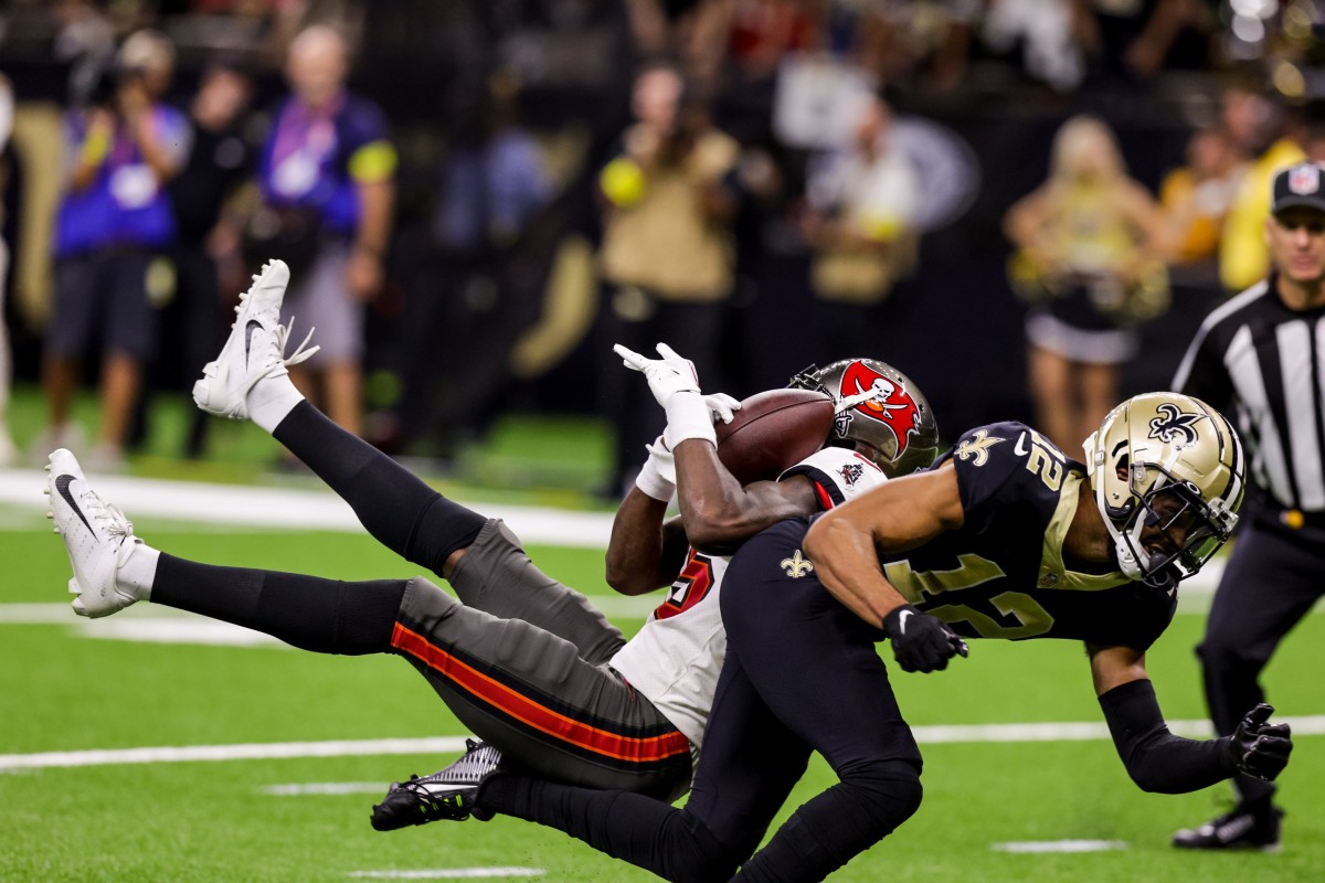 Sep 18, 2022; Tampa Bay Buccaneers cornerback Jamel Dean (35) intercepts a pass intended for Saints receiver Chris Olave (12). Mandatory Credit: Stephen Lew-USA TODAY Sports