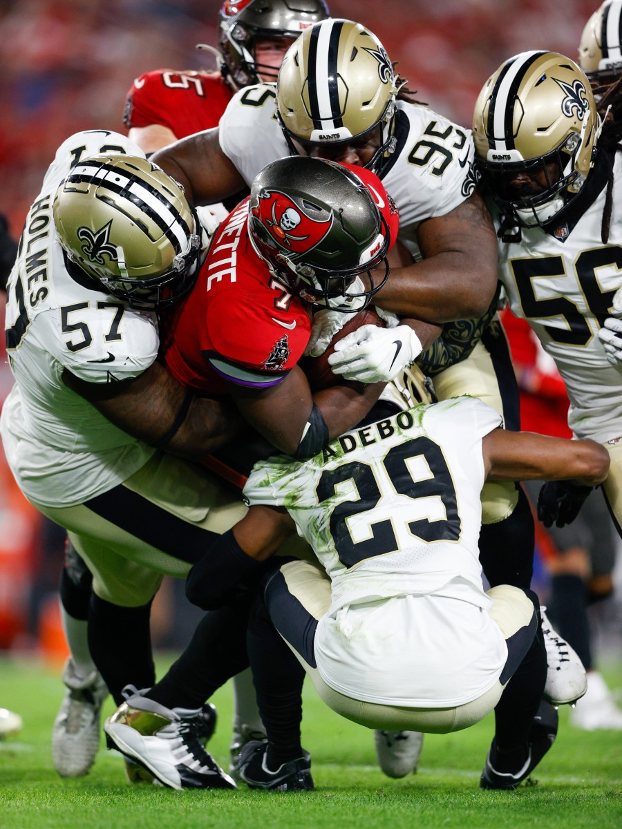 Dec 19, 2021; Tampa Bay Buccaneers running back Leonard Fournette (7) is stuffed by the New Orleans Saints defense. Mandatory Credit: Nathan Ray Seebeck-USA TODAY Sports