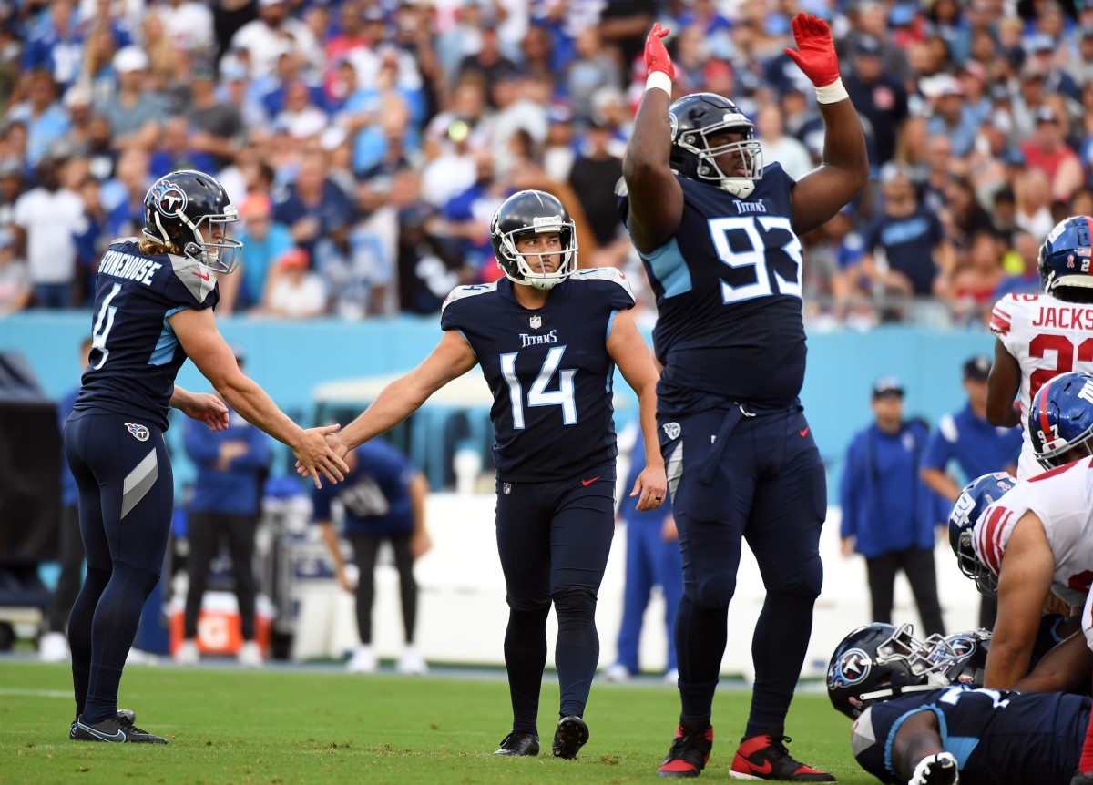 Tennessee Titans place kicker Randy Bullock (14) slaps hands with punter Ryan Stonehouse (4) after a field goal during the first half against the New York Giants at Nissan Stadium.