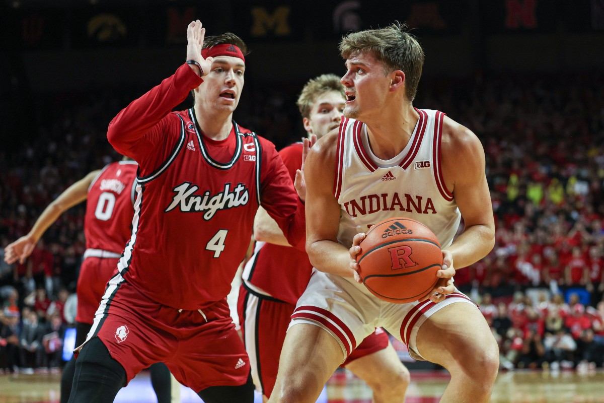 Indiana Hoosiers forward Miller Kopp (12) looks to the basket as Rutgers Scarlet Knights guard Paul Mulcahy (4) defends during the first half at Jersey Mike's Arena.