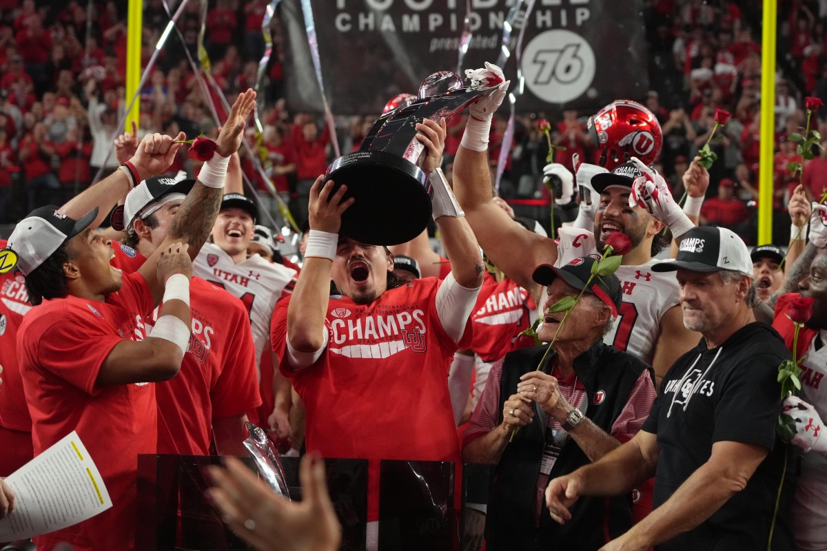Dec 2, 2022; Las Vegas, NV, USA; Utah Utes quarterback Cameron Rising hoists the Pac-12 Championship trophy after the game against the Southern California Trojans at Allegiant Stadium.