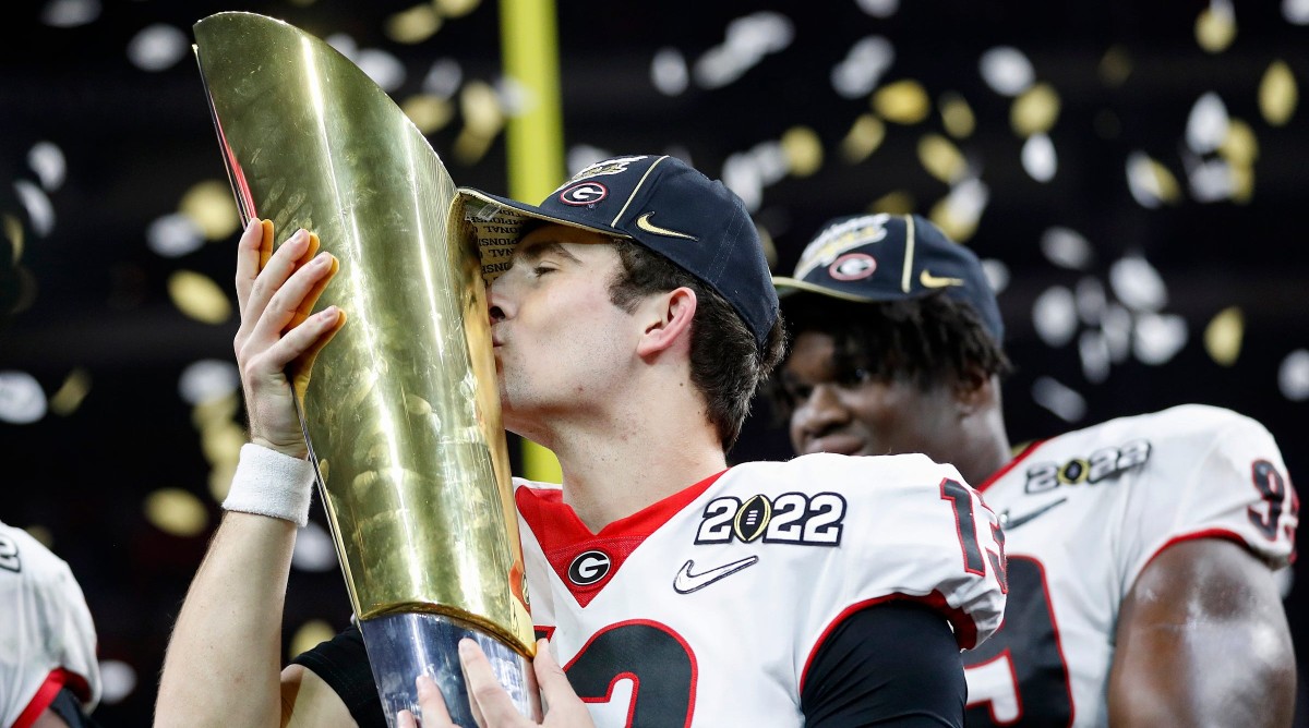 Georgia quarterback Stetson Bennett (13) kisses the trophy after winning the College Football Playoff National Championship.