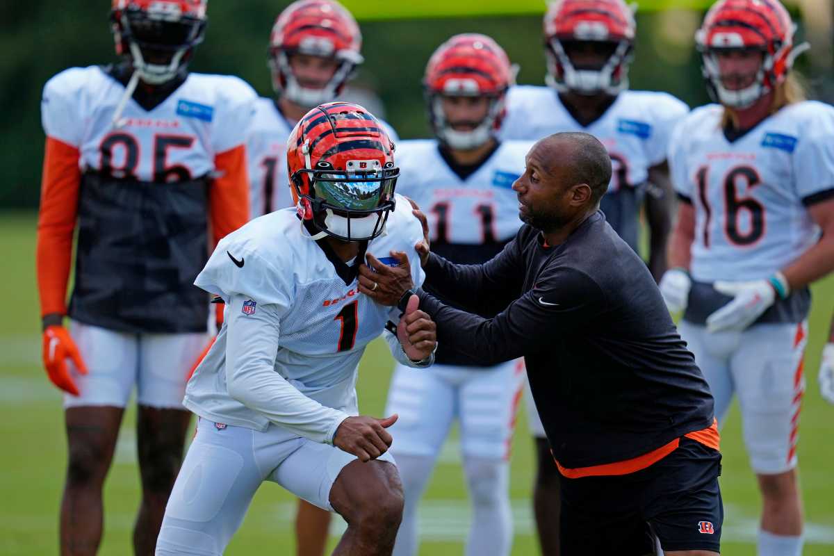 Cincinnati Bengals wide receiver Ja'Marr Chase (1) runs through a drill with wide receivers coach Troy Walters during a training camp practice at the Paycor Stadium practice fields in downtown Cincinnati on Wednesday, Aug. 17, 2022