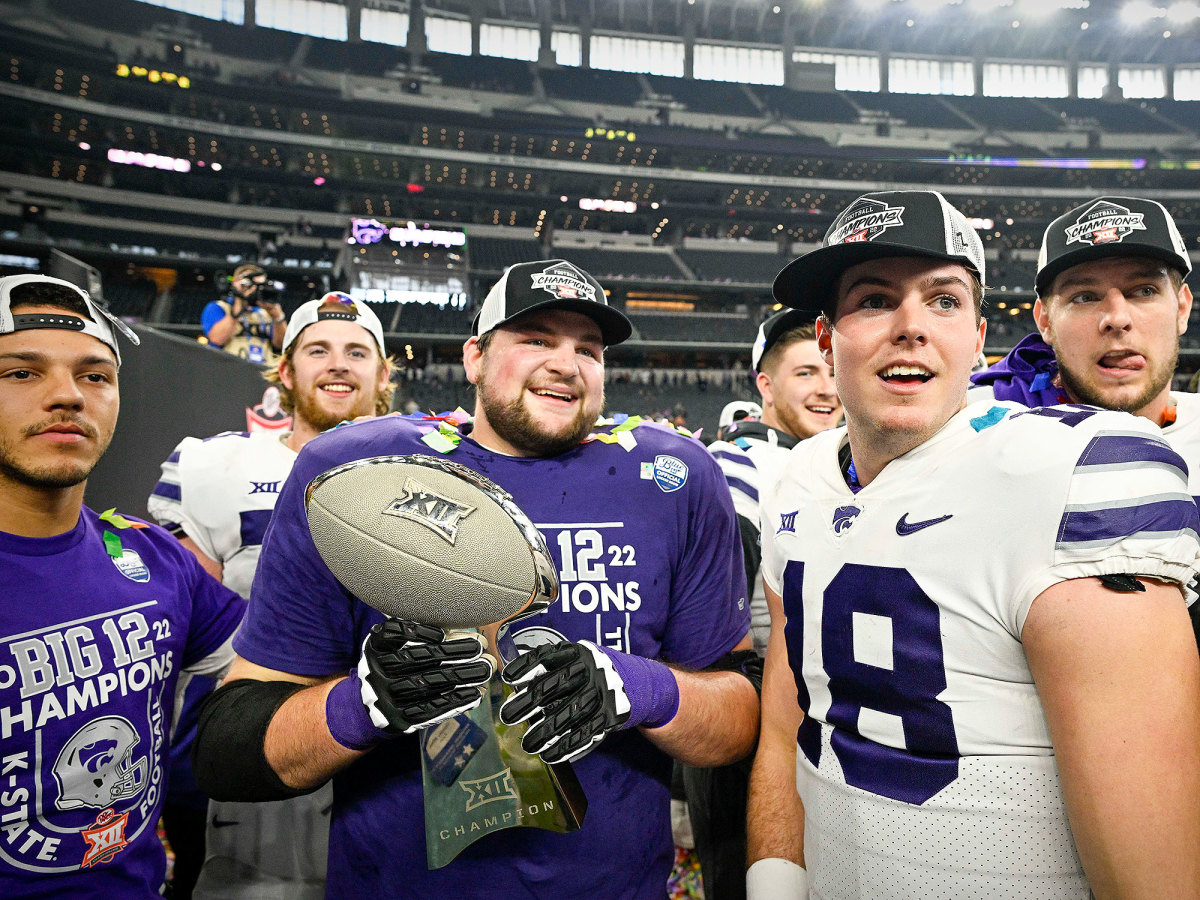 Kansas State players celebrate with the Big 12 trophy