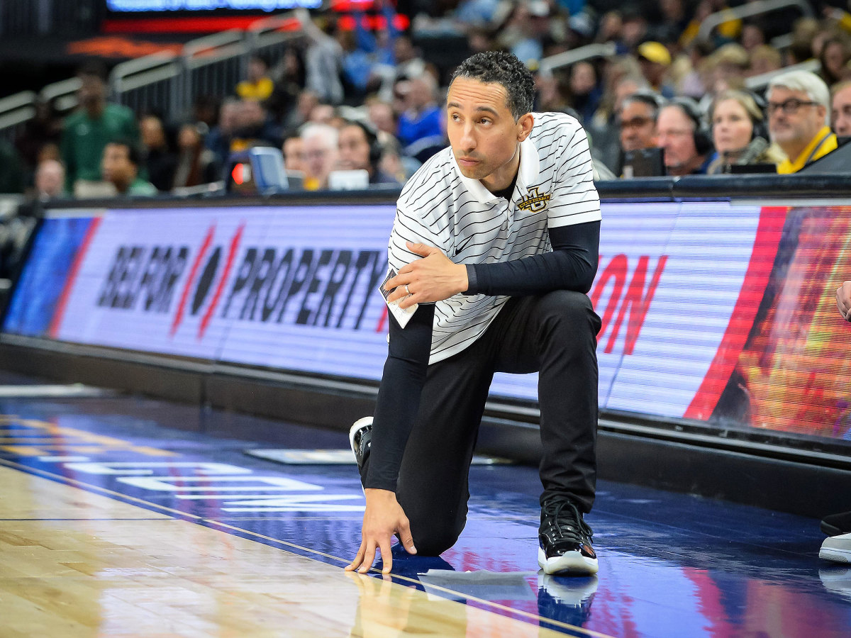 Marquette coach Shaka Smart kneels on the sideline