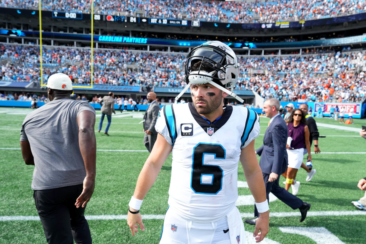 Baker Mayfield in a Carolina Panthers uniform with his helmet pulled up off his face.