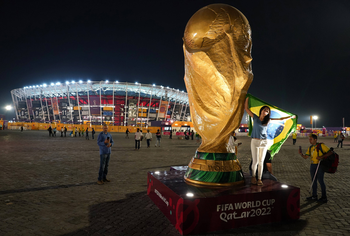 Brazil fans pose with a replica World Cup trophy