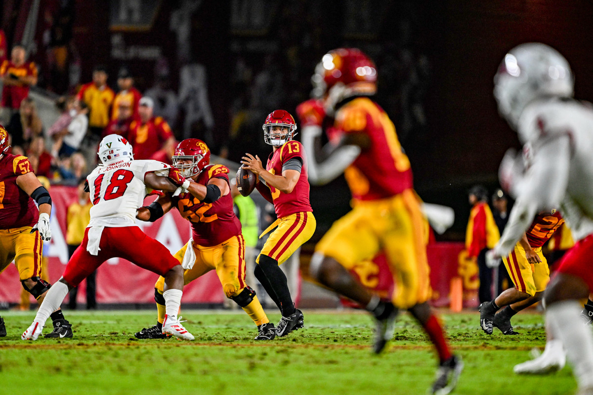 Caleb Williams steps back into the pocket before launching a pass.