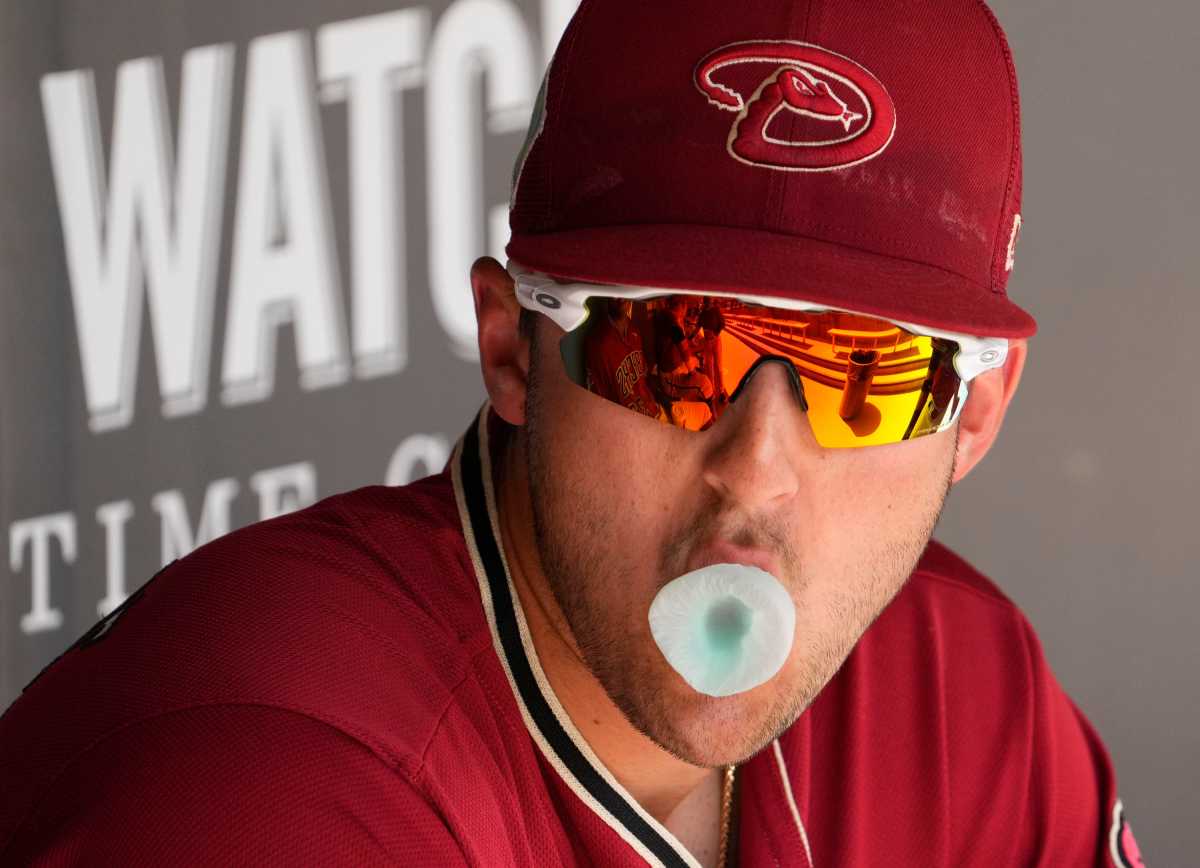 Diamondbacks prospect Dominic Canzone blows a bubble during Spring Training. (2022)