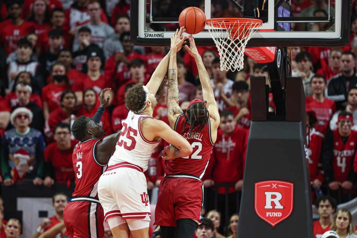 Indiana Hoosiers forward Race Thompson (25) battles for a rebound against Rutgers Scarlet Knights forward Mawot Mag (3) and guard Caleb McConnell (22) during the second half at Jersey Mike's Arena.