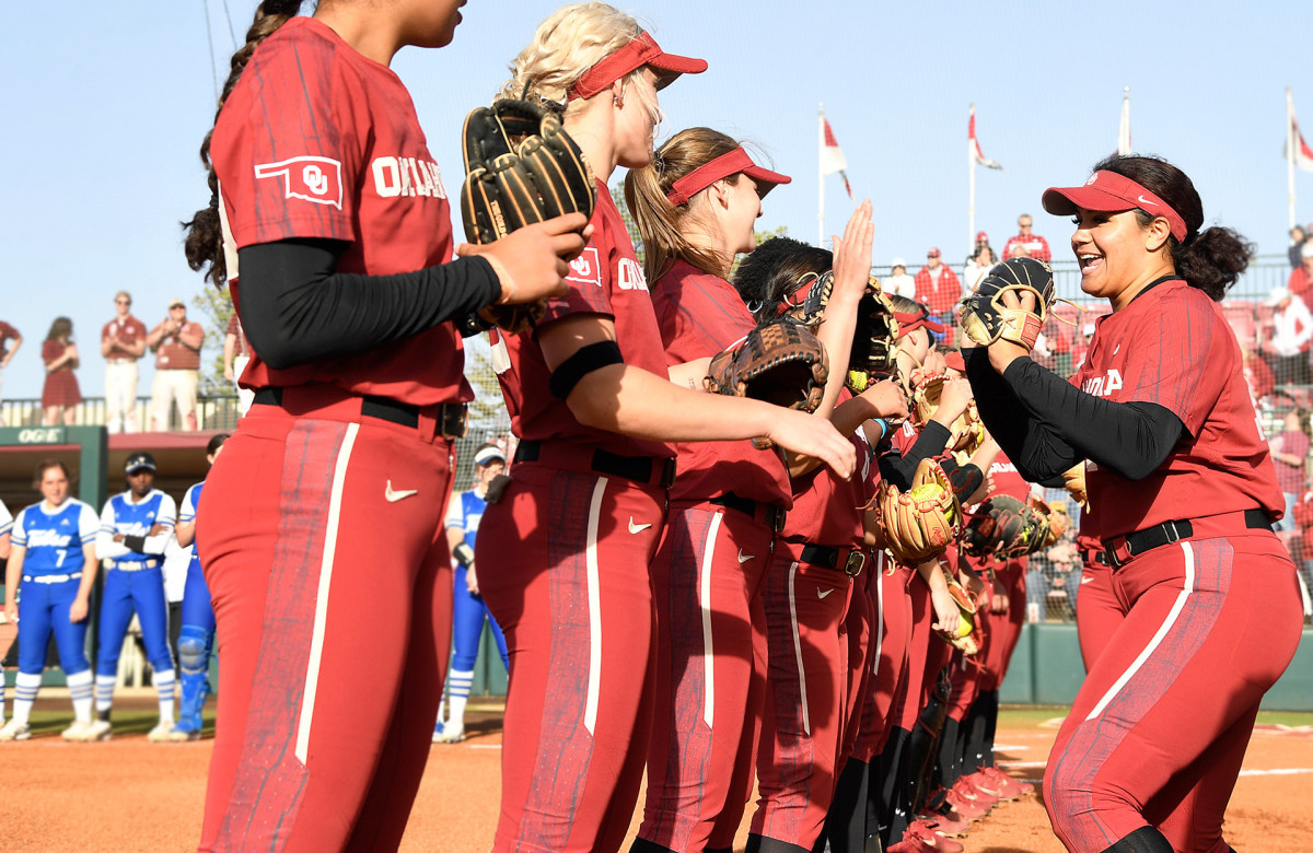 Jocelyn Alo high fives her Oklahoma Sooners teammates before a game.