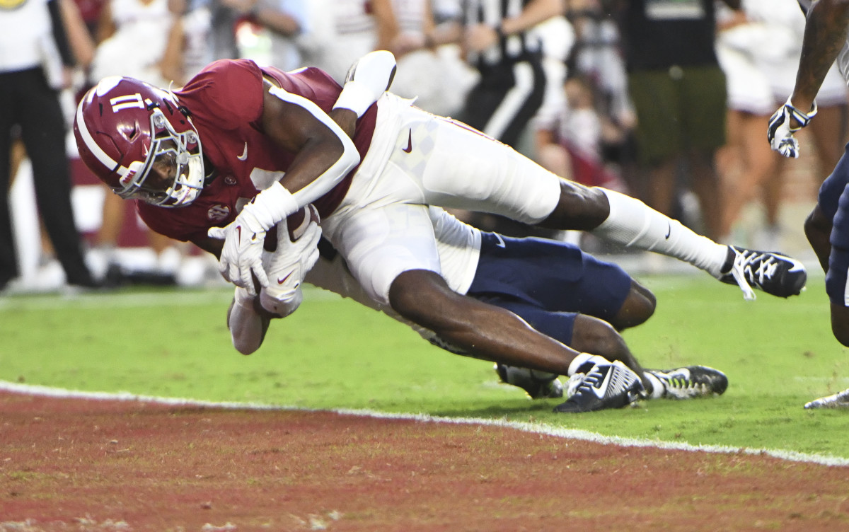 Alabama wide receiver Traeshon Holden dives into the end zone for a touchdown against Utah State.