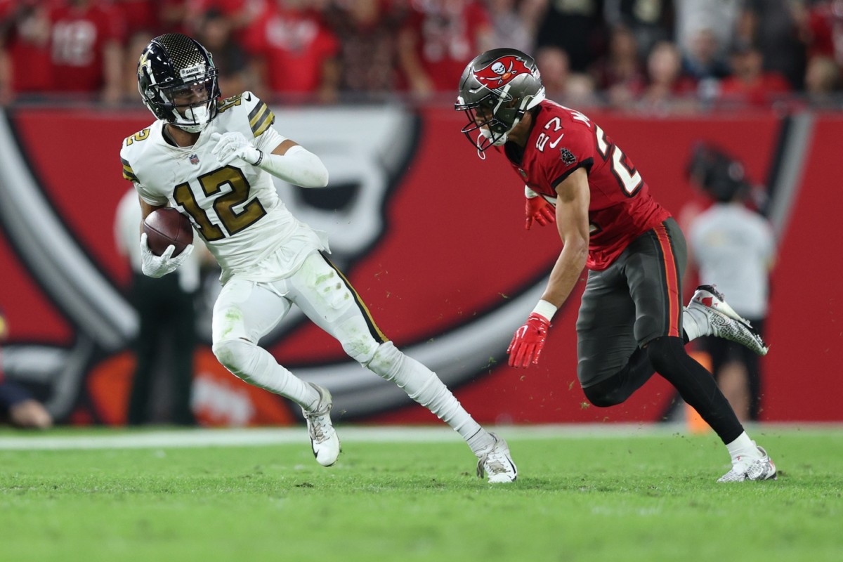 New Orleans Saints wide receiver Chris Olave (12) is chased by Tampa Bay Buccaneers cornerback Zyon McCollum (27). Mandatory Credit: Nathan Ray Seebeck-USA TODAY Sports