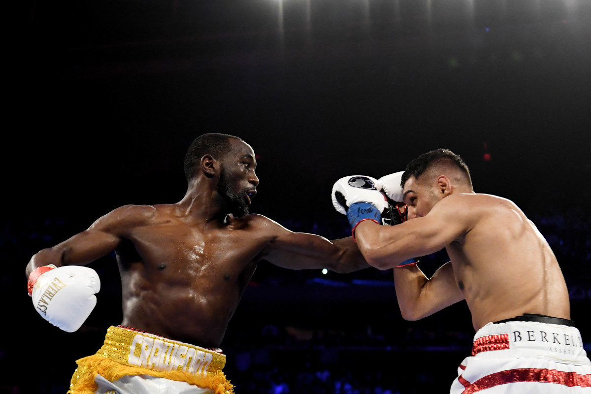 Terence Crawford (yellow trunks) trades punches with Amir Khan (white trunks) during the WBO welterweight title fight at Madison Square Garden.
