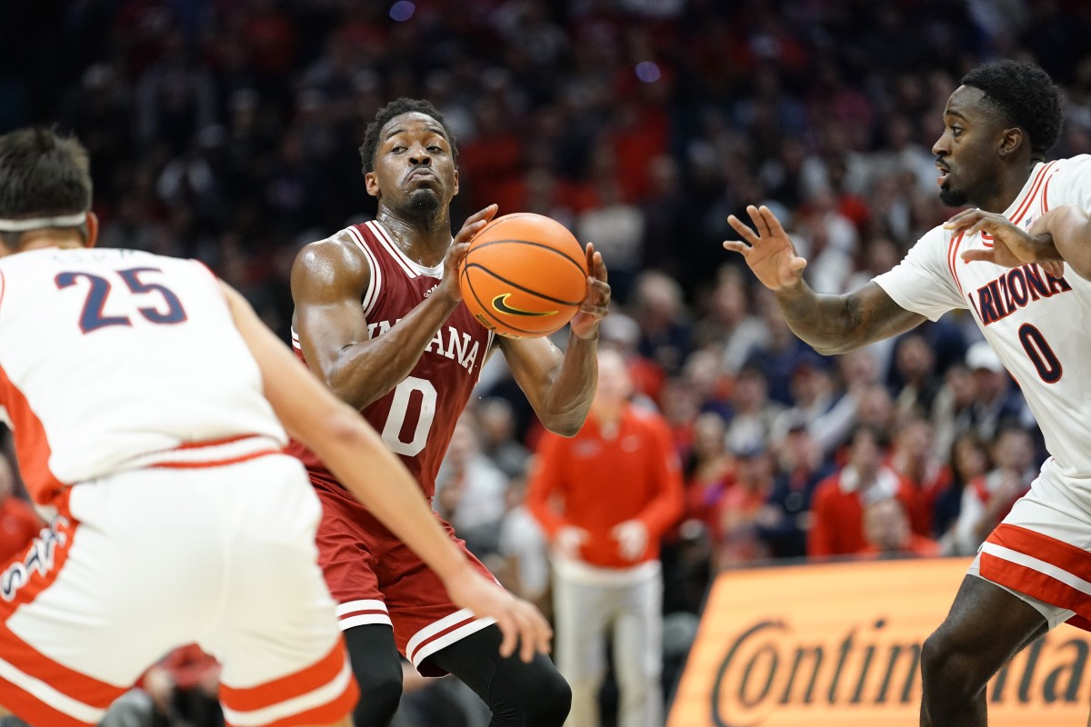 Indiana Hoosiers guard Xavier Johnson (0) controls the ball against Arizona Wildcats guards Courtney Ramey (0) and Kerr Kriisa (25) during the second half at MGM Grand Garden Arena.