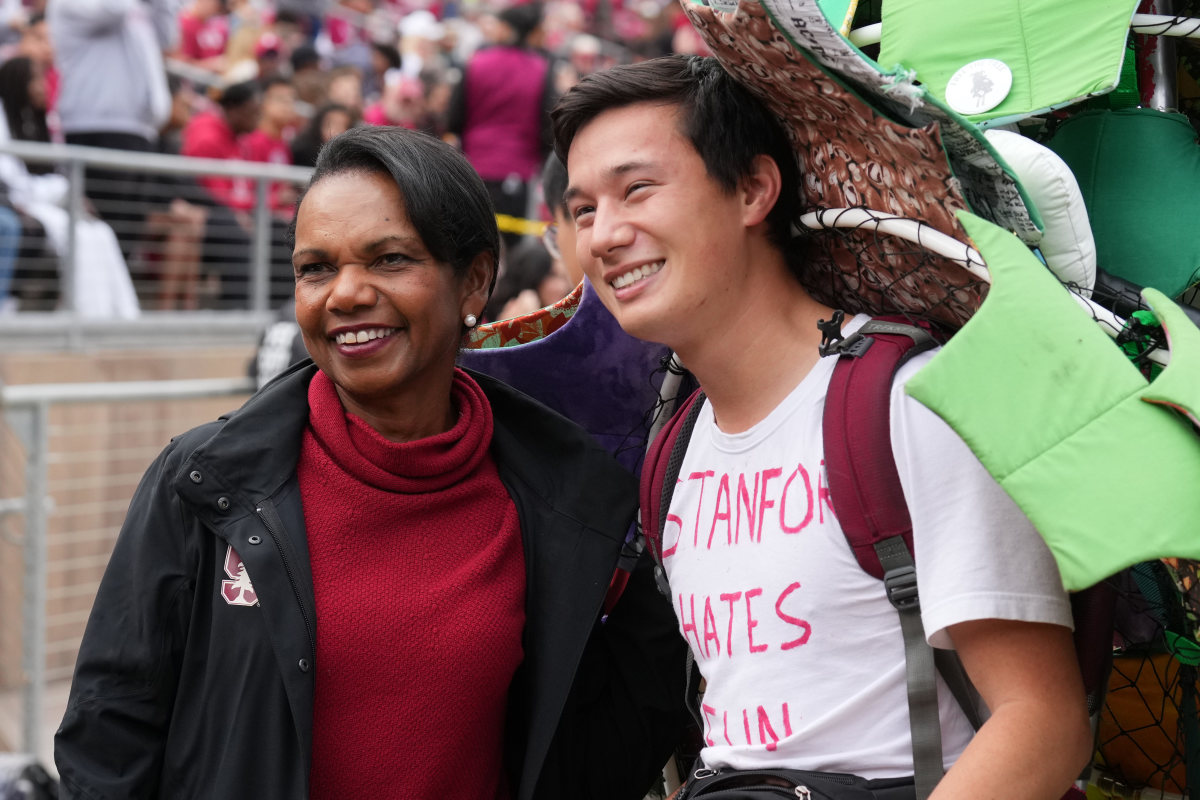 Stanford, California, USA; Former secretary of state Condoleezza Rice poses for a photo with the Stanford Cardinal tree mascot during the second quarter against the Washington State Cougars at Stanford Stadium.