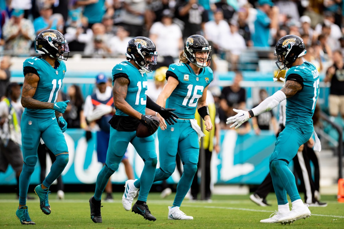Jacksonville Jaguars wide receiver Christian Kirk (13) and Jacksonville Jaguars quarterback Trevor Lawrence (16) smile after scoring a touchdown during the second half against the Las Vegas Raiders at TIAA Bank Field.