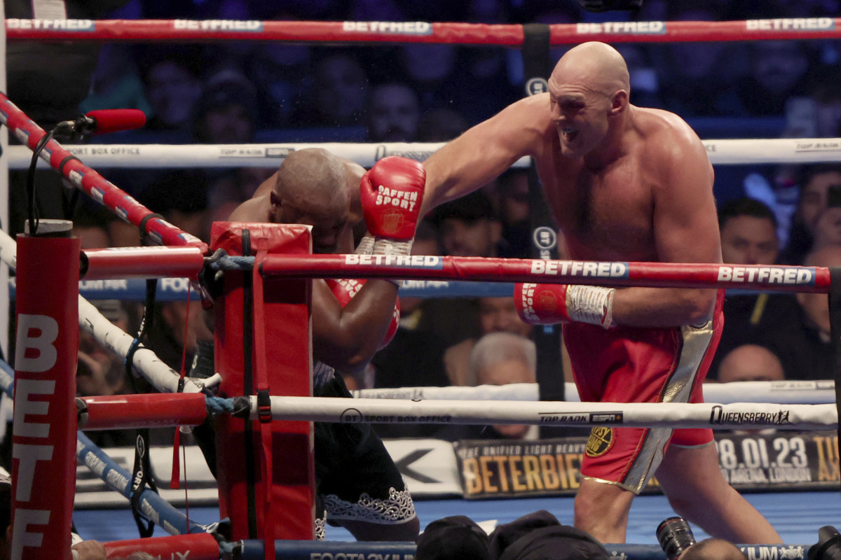 Tyson Fury, right, lands a punch during his WBC heavyweight championship boxing match against Derek Chisora at Tottenham Hotspur's White Hart Lane stadium London, Saturday Dec. 3, 2022.