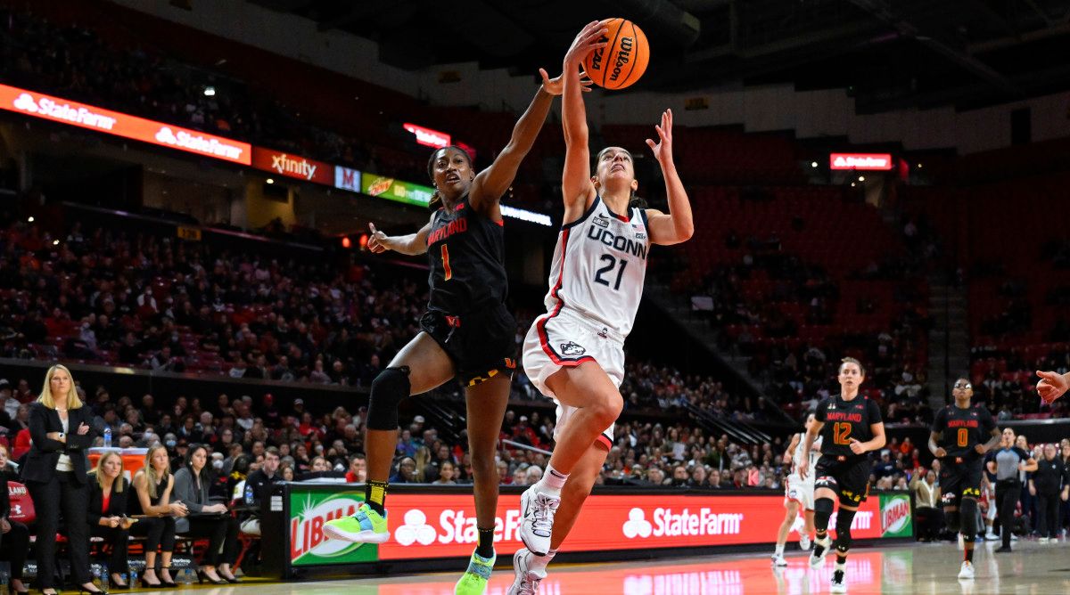Connecticut guard Ines Bettencourt goes to the basket for a lay up and avoids defender Maryland guard Diamond Miller.